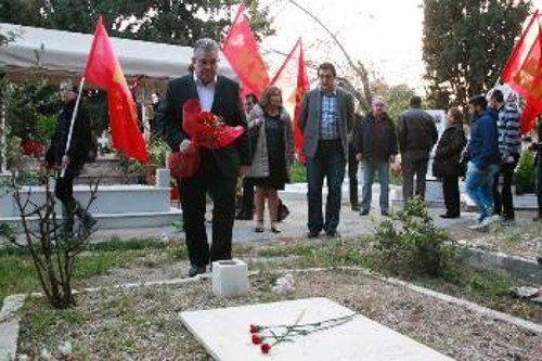 Λίγο πριν την εκδήλωση ο Δ. Κουτσούμπας άφησε ένα μπουκέτο κόκκινα γαρίφαλα στον τάφο του Ν. Μπελογιάννη στο Γ' Νεκροταφείο