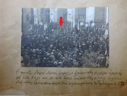 Κύριος ομιλητής (φαίνεται αχνά κάτω από το κόκκινο βελάκι), την Πρωτομαγιά του 1922, στην εκδήλωση που οργάνωσε η Πανεργατική Ενωση των συνασπισμένων κερκυραϊκών σωματείων