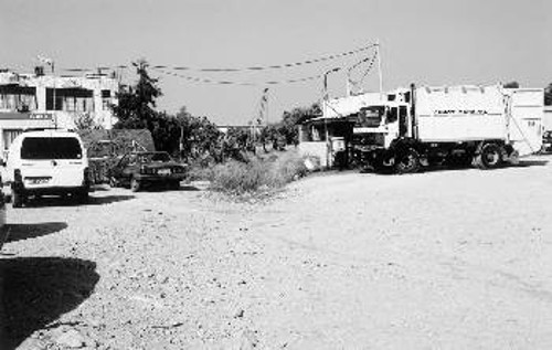 Στο βάθος, ανάμεσα στο ΙΧ και τα φορτηγά του δήμου, διακρίνουμε το ρέμα Σούρες να ...διασχίζει το εργοτάξιο