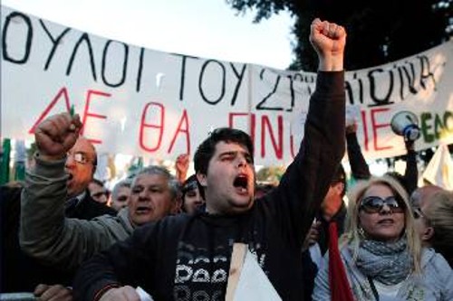 «Δούλοι του 21ου αιώνα δε θα γίνουμε», γράφει το πανό στη χτεσινή διαδήλωση έξω από την κυπριακή Βουλή
